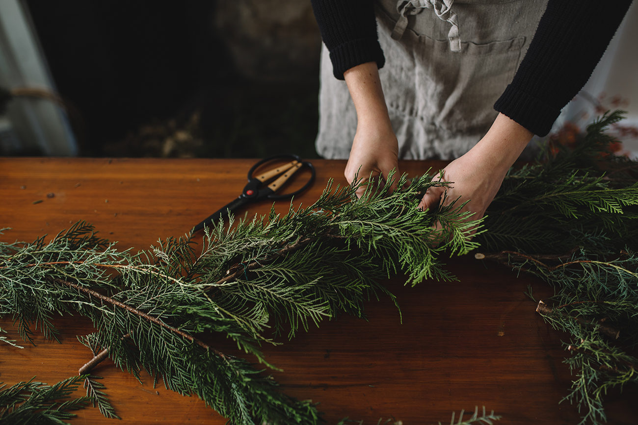 use natural greenery to decorate gifts as you are navigating holiday gift-giving