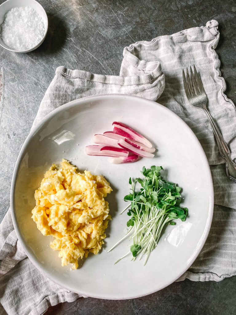 Quick fermented radishes served with scrambled eggs and radish sprouts