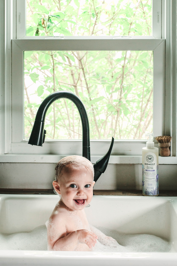 Baby having a bath in a farmhouse sink
