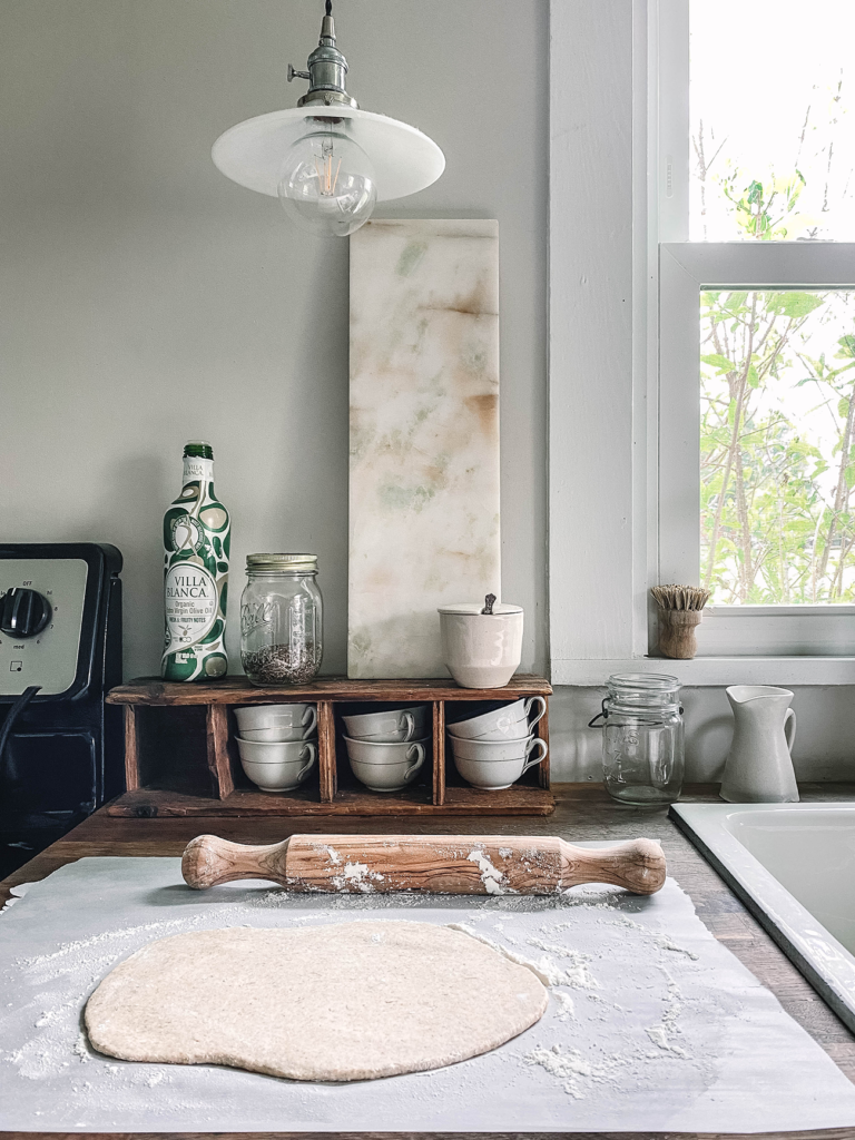 Sourdough rolled out on butcher block countertop